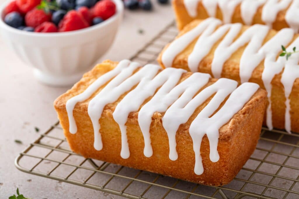 Classic pound cake with powdered sugar glaze dripping over