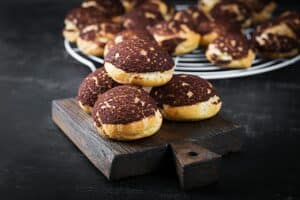 Shu Cake. Tasty profiterole with cream on the plate. Copy space.